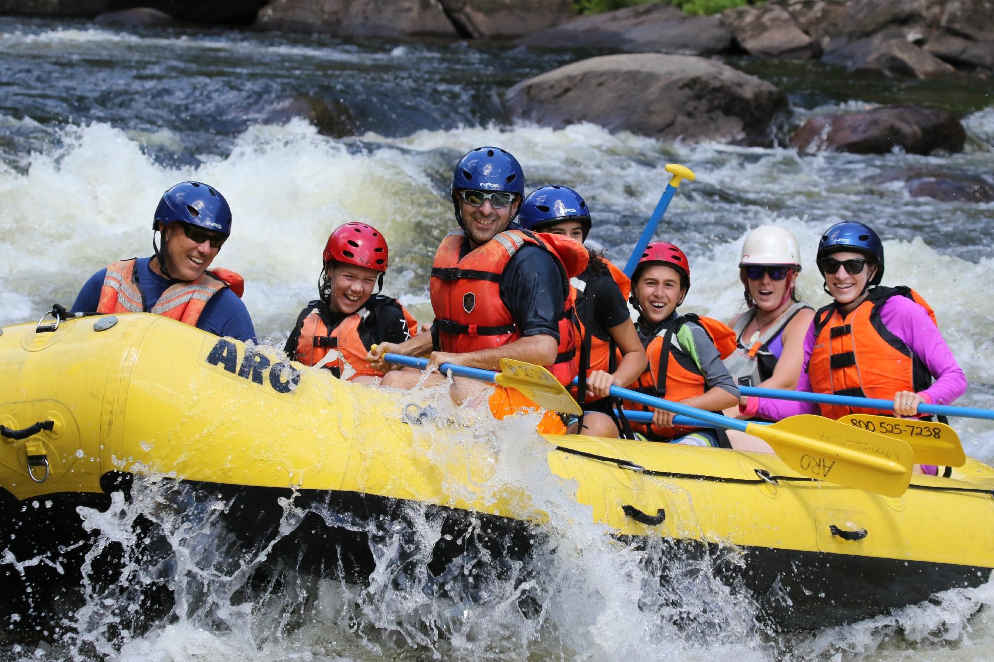 a group of people riding on a raft in the water